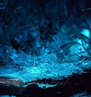 an ice cave with a blue light in it