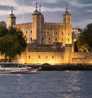 a boat in the water in front of a castle