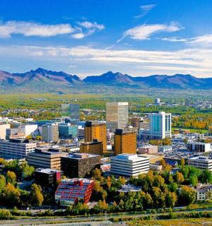 an aerial view of a city with mountains in the background