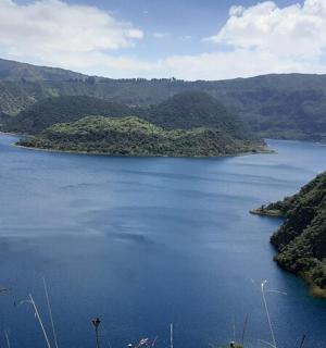 a large body of water with mountains in the background
