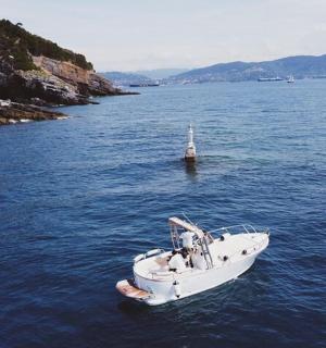 一艘白色的小船漂浮在一大片水域中