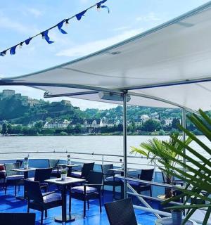 a restaurant with tables and chairs and a view of the water
