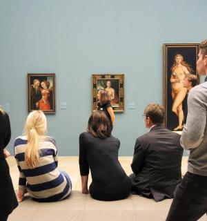a group of people looking at art in a museum