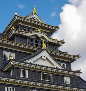 a tall building with a sky in the background