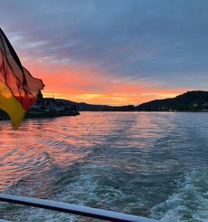 a flag on the side of a boat on a lake