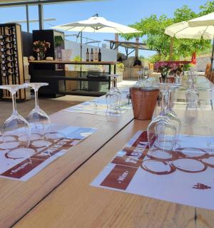 a long wooden table with wine glasses on it