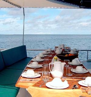 a long table on a boat in the ocean