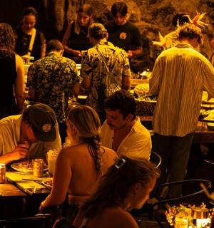 a group of people sitting at tables in a restaurant