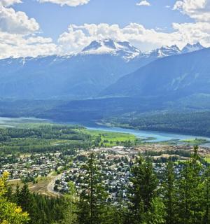 a view of a town with a lake and mountains