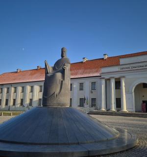 a statue in front of a large building
