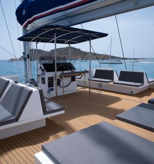 a boat with chairs and a table on the deck