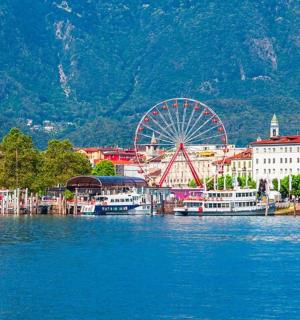 a city with a ferris wheel on the water