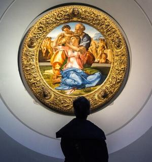 a person looking at a painting in a museum