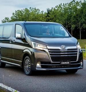 a van is driving down a road