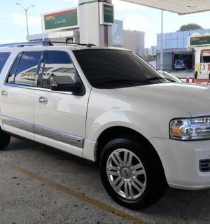 a white suv parked at a gas station