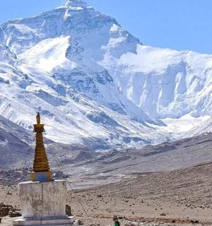 a mountain with a tower in the middle of a valley