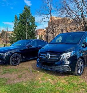 two cars parked next to each other in a field