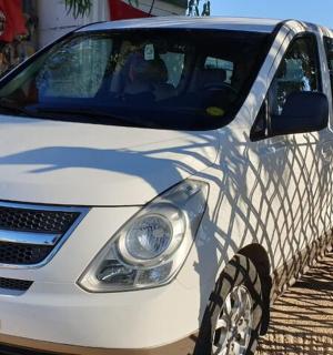 a white car parked in front of a building