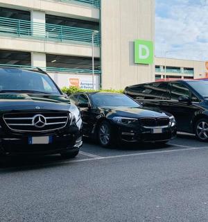 three cars parked in a parking lot in front of a building