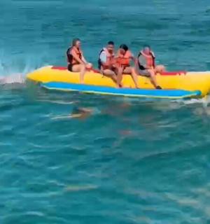 a group of people riding on a yellow raft in the water