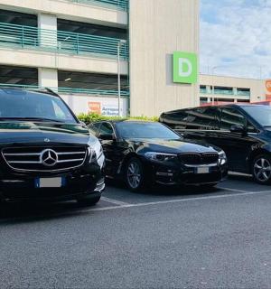 three cars parked in a parking lot in front of a building
