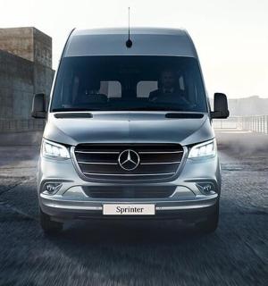 a silver mercedes van parked on a street