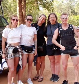 a group of people standing next to a car