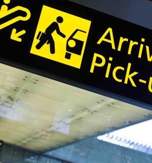 a sign for an airport pick up sign in an airport