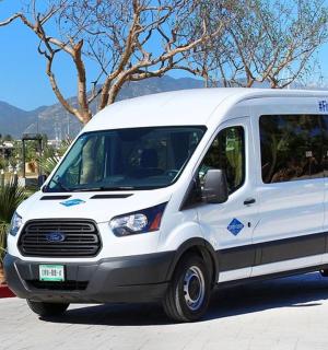 a white van parked next to a body of water