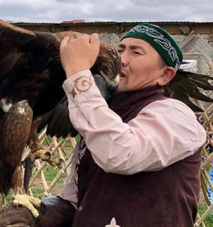 a woman holding an eagle on her arm