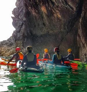 a group of people in kayaks in a cave