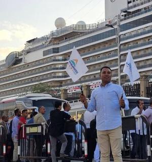 muž stojící před davem s vlajkami