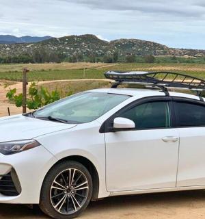 a white car with a rack on the roof