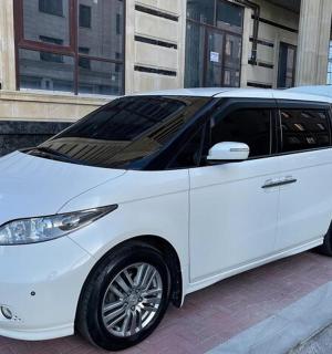 a white car parked in front of a building