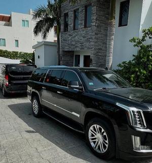 a black limousine parked in front of a house
