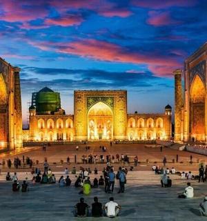 a group of people sitting in front of a building