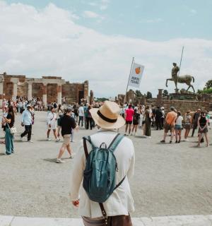 a crowd of people standing in front of a statue
