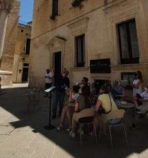 a group of people sitting in chairs in front of a building