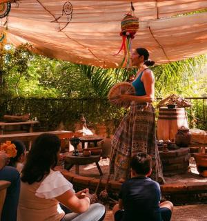 a woman standing under a tent with a group of people