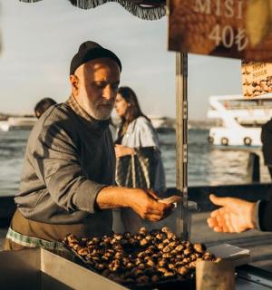 a man is preparing food at a food stand