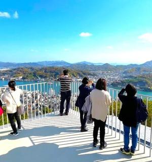 a group of people standing on top of a viewing deck