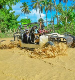 a group of people riding in an off road vehicle