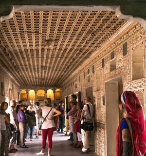 a group of people standing in a hallway in a building