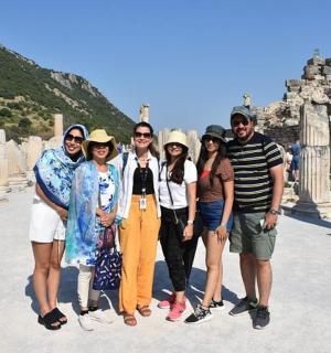 a group of people posing for a picture at the acropolis
