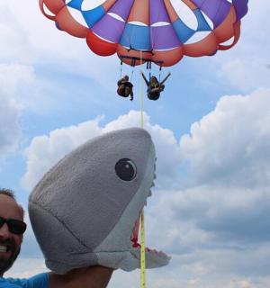 a man is holding up a hot air balloon