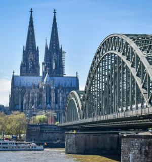 a bridge over a river with a large cathedral