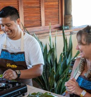 a man and a woman in a kitchen preparing food