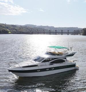 a boat on the water with a bridge in the background