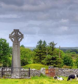 a clock tower in the middle of a field