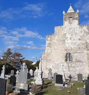 an old church with tombstones in a cemetery